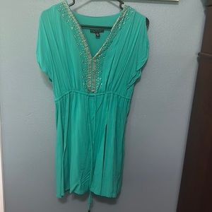 Teal/green dress with gold embellishment on front and side slits on arms